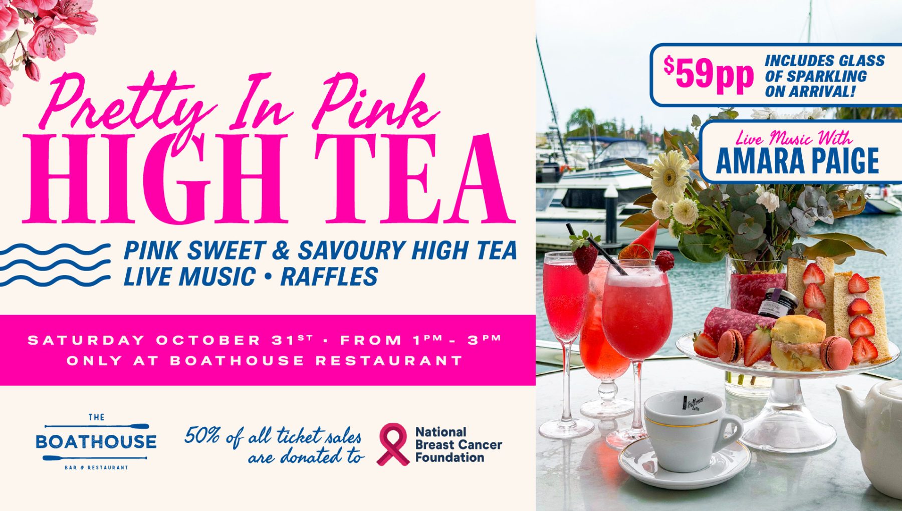 A table set for high tea featuring pink drinks, desserts, and a vase of flowers, with a waterfront view and boats in the background.