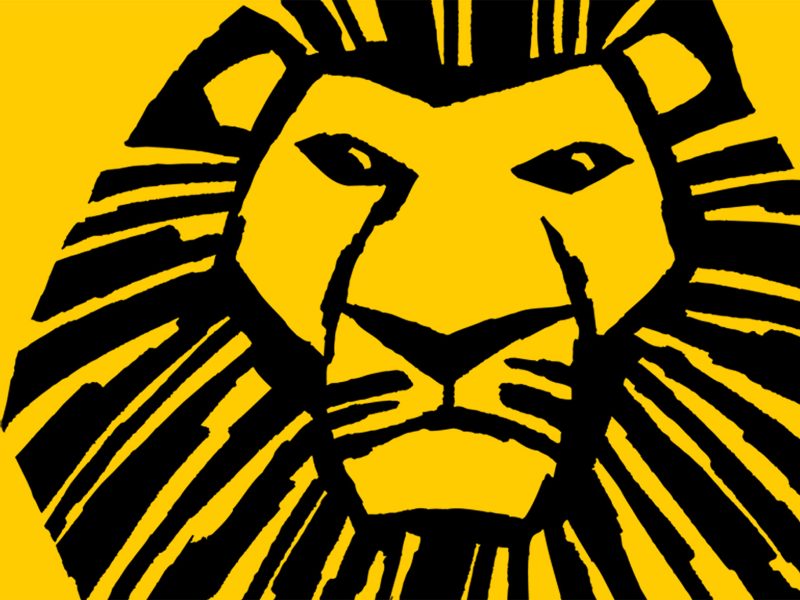 A stylized black lion's face with a dramatic mane, set against a bright yellow background.