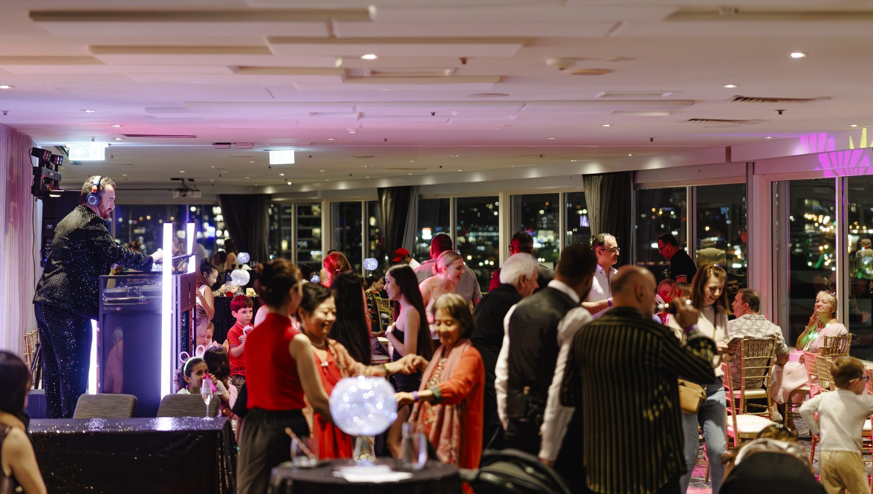 Guests enjoying a festive rooftop event with Brisbane city views at Rydges South Bank.