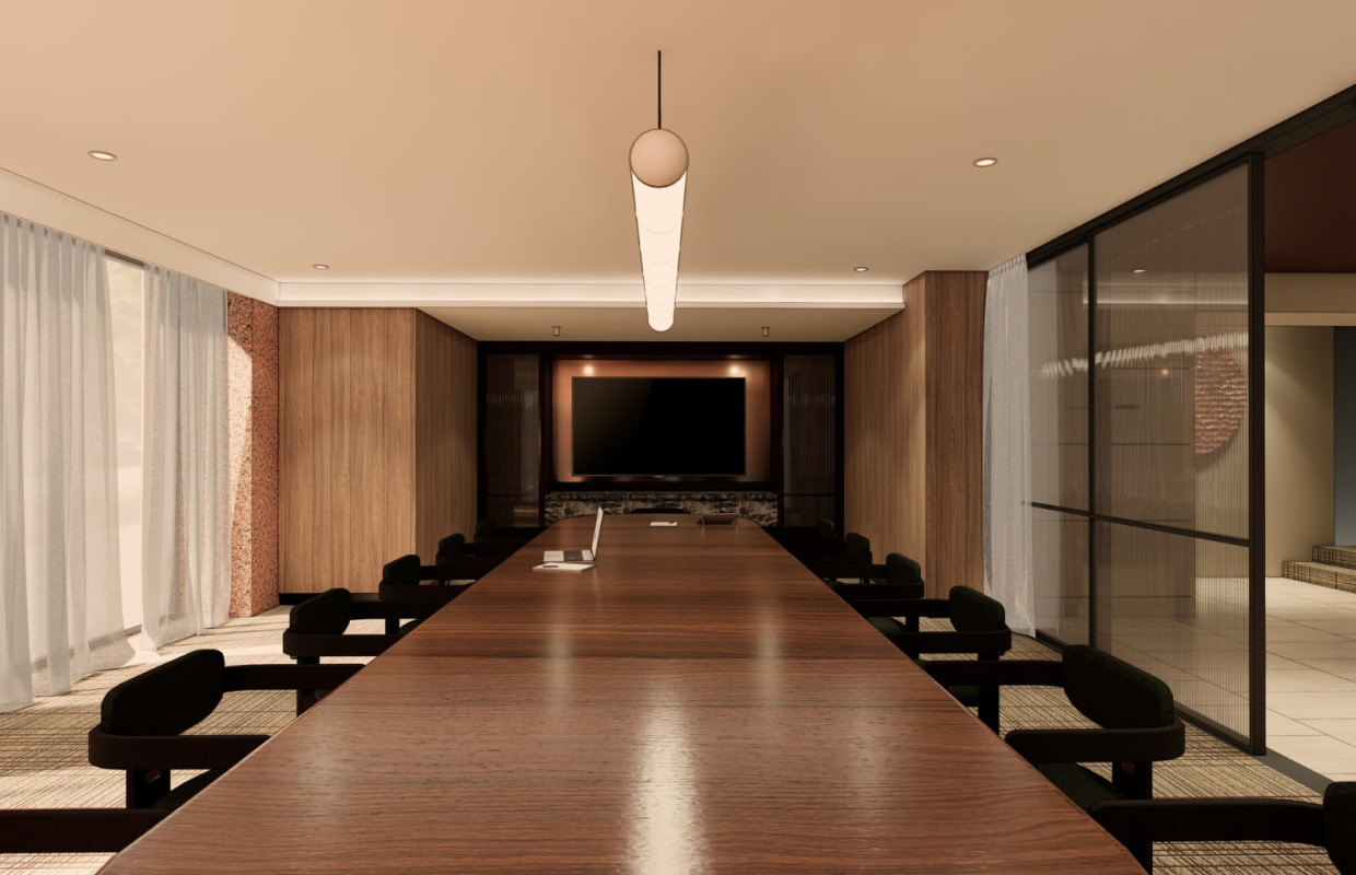 A long wooden conference table with black chairs faces a wall-mounted screen in a warm, wood-paneled meeting room.